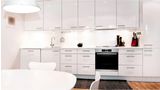 Kitchen with lighting inside Bosch showroom featuring oven hob and hood.