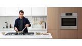 Person cooking with gas in Bosch kitchen
