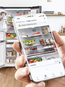 Person using mobile app to look inside fridge