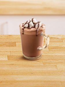 Glass cup filled with hot chocolate.