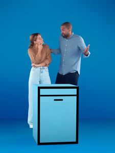 Couple standing over appliance