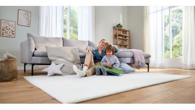Woman and child sat on living room floor