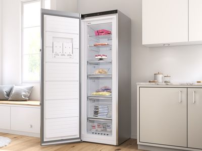 Open freestanding freezer in a bright, modern kitchen.