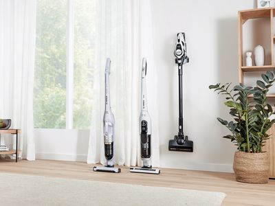 A lineup of three different Bosch cordless vacuum cleaners in a room