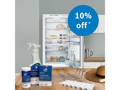 Bosch fridge open with accessories and cleaning products on kitchen counter