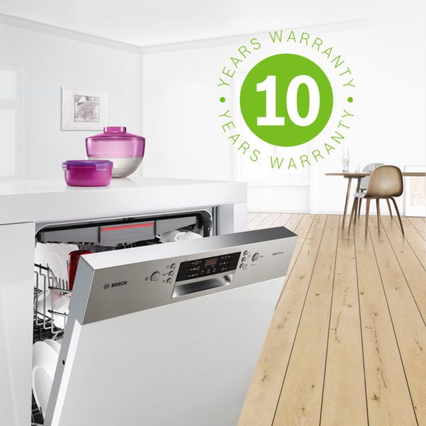 Bosch built-in dishwasher in a modern kitchen with a dining area in the background. Green warranty icon shows anti-rust extended warranty for 10 years.