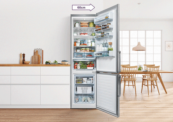 Відкритий великий холодильник Bosch з морозильною камерою, в ньому - деко, великий кавун та пляшки.