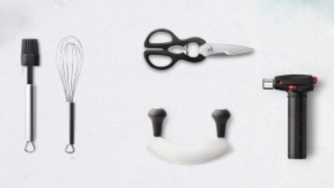 Black and white kitchen utensils: scissors, basting brush, whisk, rocker cutter and kitchen torch, displayed against a white backdrop