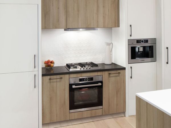 Compact kitchen with a built-in stove, hood and coffee machine