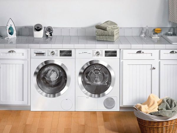 Side-by-side compact washer and dryer in a laundry room
