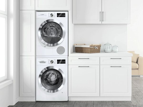 Stacked washer and dryer in a modern white farmhouse kitchen