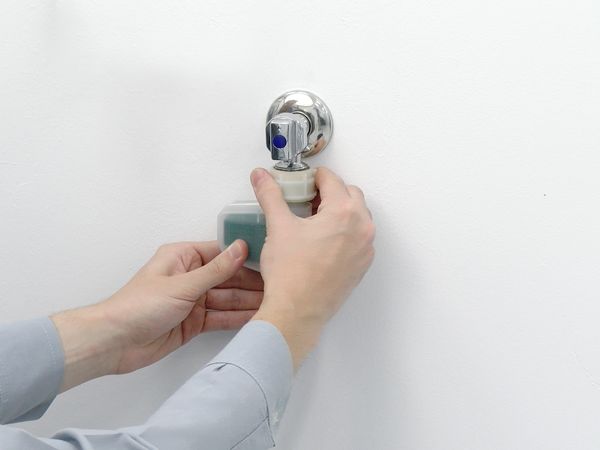 Person closing a water tap