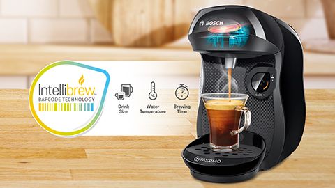 Black Tassimo machinec with coffee cup