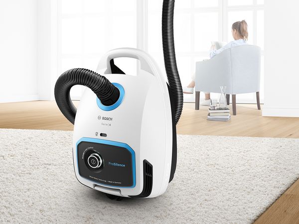 Quiet bagless Bosch ProSilence vacuum on a light grey, high-pile rug
