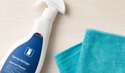 Bosch fridge cleaner in a spray bottle and a turquoise cleaning cloth.