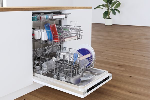 Fully open dishwasher door showing different items inside
