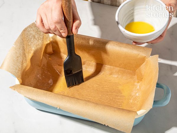Brushing butter to a pan 