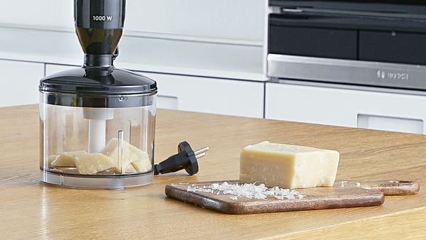 Parmesan cheese being grated in one of the Bosch MaxoMixx attachments. 