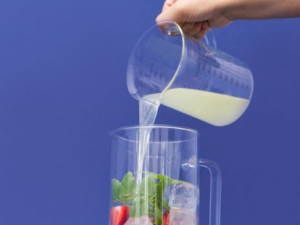 Pouring lemon juice over glass