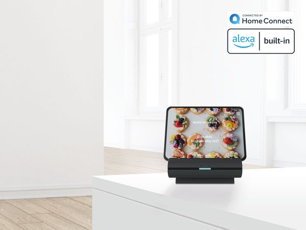 Tablet sat in smart dock on kitchen countertop with Amazon Alexa logo