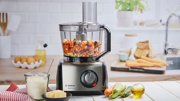 A MultiTalent 8 food processor that's just chopped colourful vegetables.