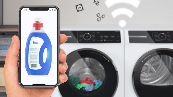 User controlling a washing machine via the Home Connect app.