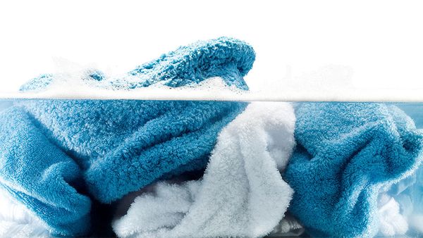 Brightly coloured, extra-clean terrycloth items soaking in water.