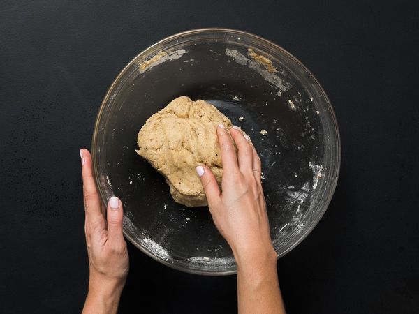 Kneading dough into a bowl