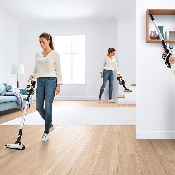 Person using Unlimited Serie 6 cordless vacuum cleaner around house
