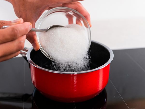 Adding sugar into the boiling water