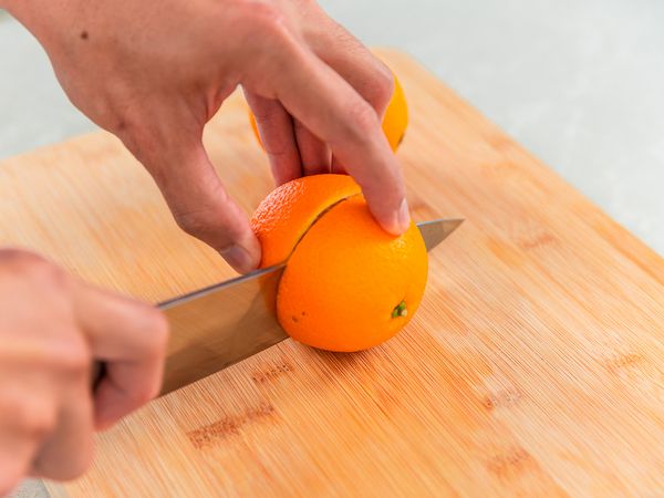 cutting oranges into two halves
