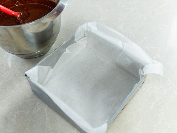 Line a 6-inch square baking tin with baking paper.