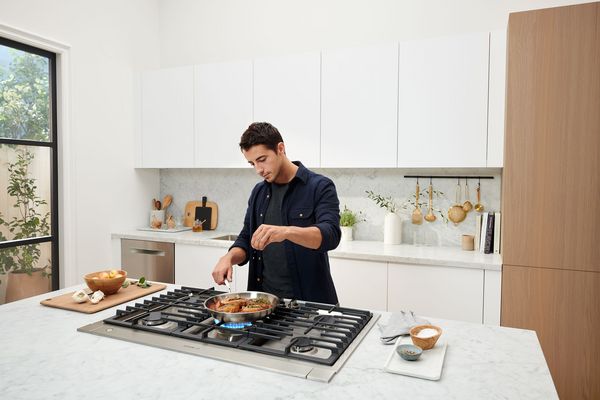 Person cooking on a bosch cooktop