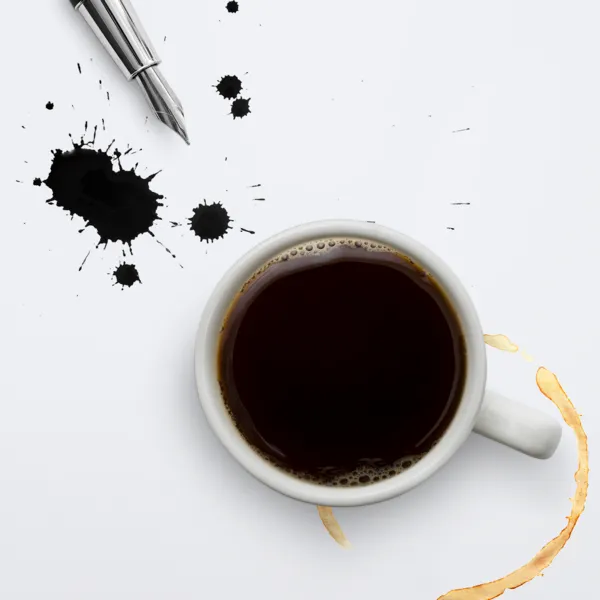 a stain on a cloth, a cup of coffee, ink