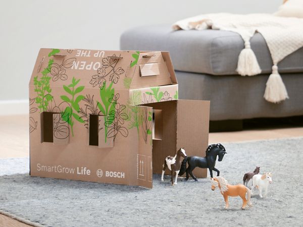 The SmartGrow Life box on the floor converted into a play farmhouse.