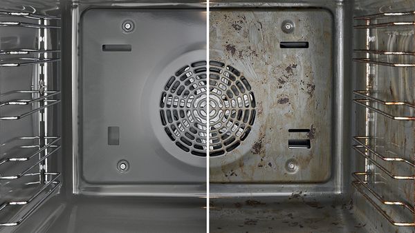 Inside of an oven with a microwave. Left half clean, right half dirty.