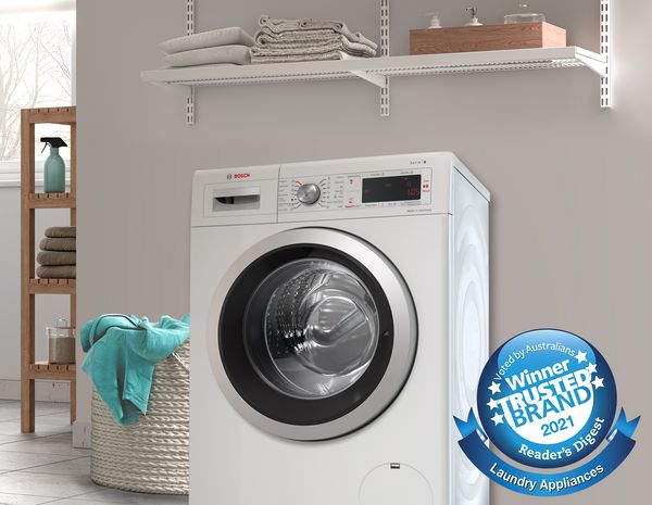 Bosch freestanding washer with gym bag to the left and best in test badge 