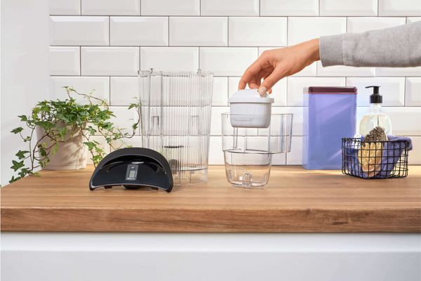 A person changes the BRITA MAXTRA+ water filter of the TASSIMO coffee machine MYWAY 2.