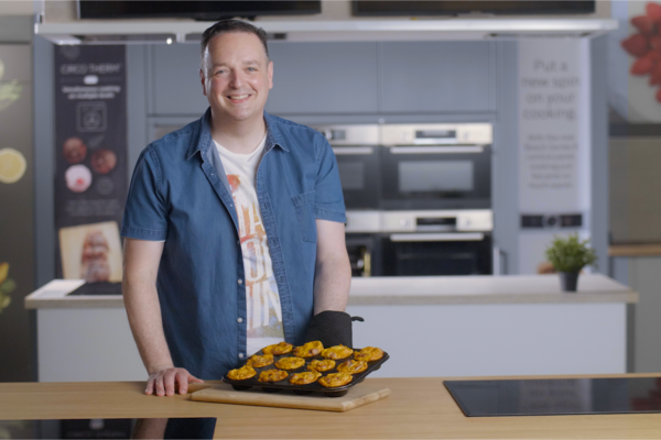 The Cupcake Bloke holding a tray of breakfast muffins