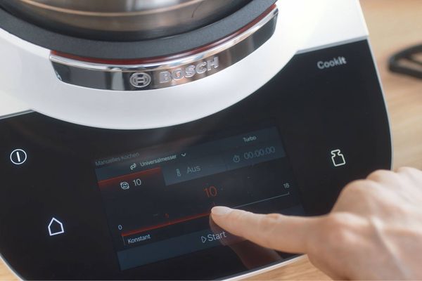 Jemand klickt auf das Display des Bosch Cookit, um die Geschwindigkeit des Universalmessers einzustellen.