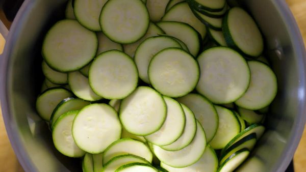 Top view of a cookit in which cucumbers sliced and grated.