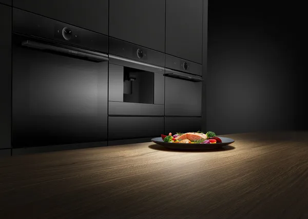 Serie 8 ovens in een keuken. Op het werkblad staat een bord met zalm en groenten.
