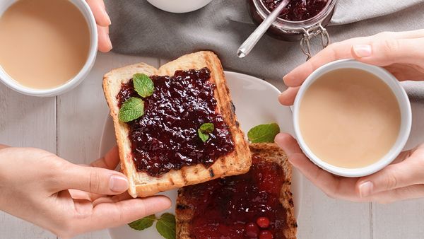 Berry compote on toast with cups of tea