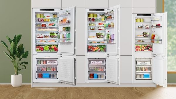 Three built in fridge freezers next to eachother with open doors