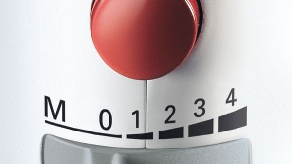 A top view of a 5-speed hand mixer's handle with focus on the speed settings.