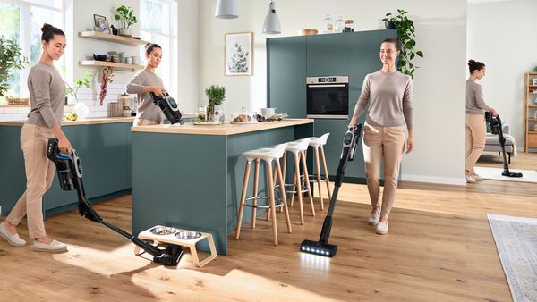 Woman vacuuming the kitchen with Unlimited 10