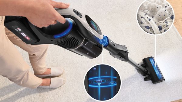 A woman operates an Unlimited 10 vacuum cleaner to effectively clean the floor in her home.