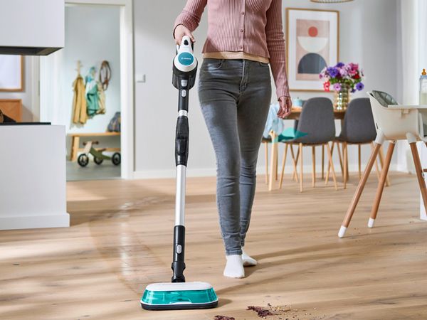 Person using unlimited 7 aqua to clean hard flooring in home
