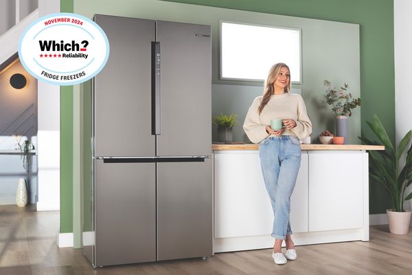 Bosch multi-door refrigerator with the door open, showcasing its interior in a modern kitchen setting with which award banner overlay