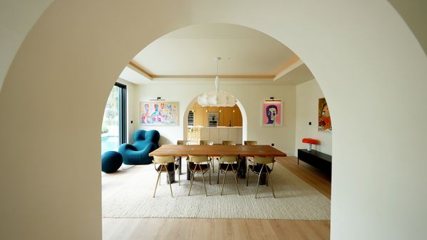 A view through an interior arch into the dining room and ending in the kitchen fitted with Gaggenau 400 series appliances.